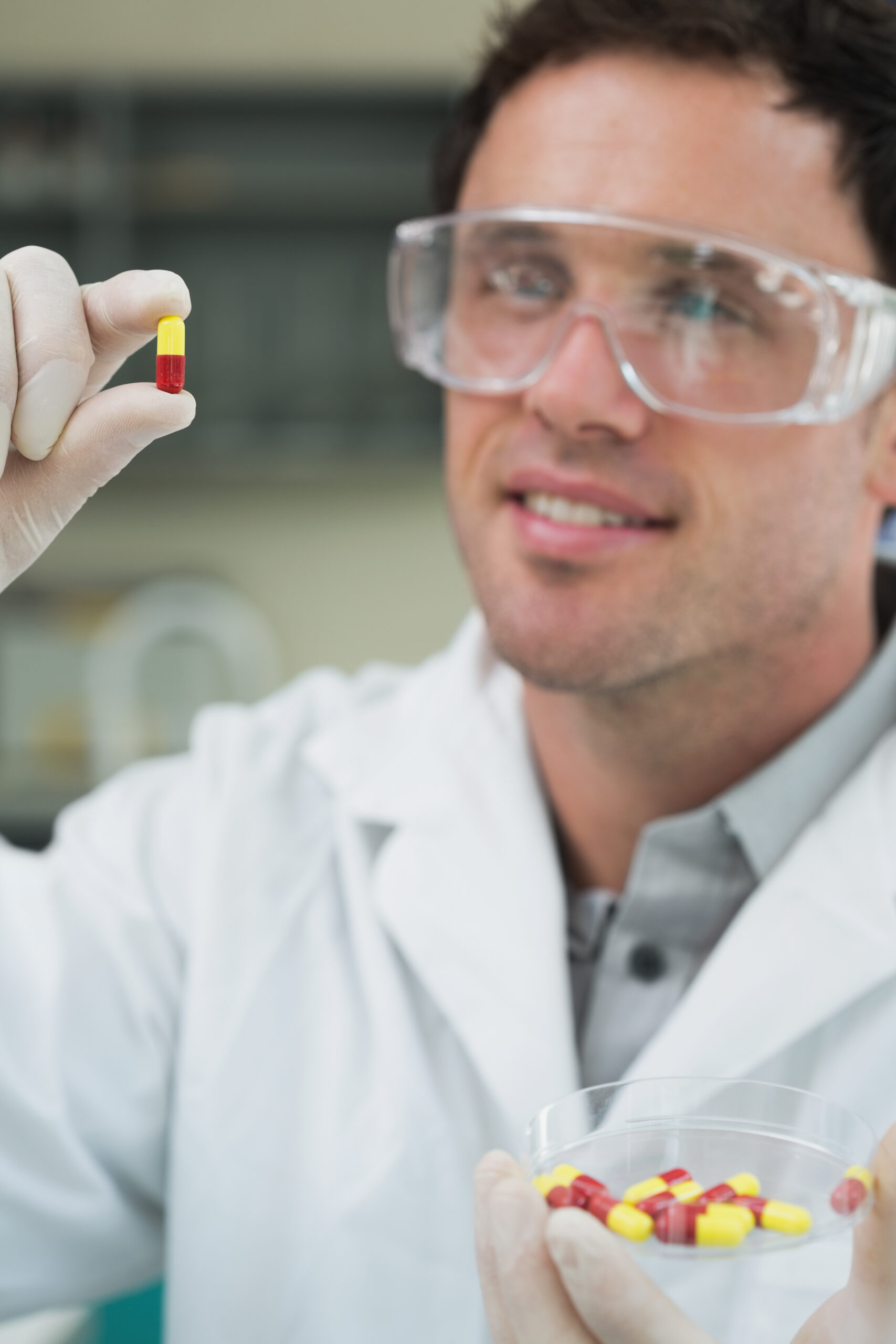 Close-up of a male scientist analyzing pills in the laboratory
